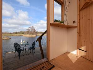 a view from the porch of a cabin with a table and chairs at 1 Bed in Thetford 57900 in East Harling