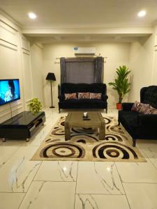 a living room with a couch and a coffee table at Aesthetic Scenic Luxurious Apartment - Bahria Heights in Rawalpindi