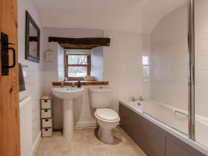 a bathroom with a toilet and a sink and a bath tub at 3 Bed in Barnstaple 60511 in Swimbridge +16 photos