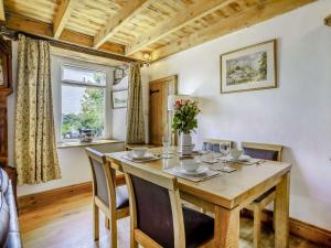 a dining room with a wooden table and chairs at 2 Bed in Gower 62019 in Reynoldston