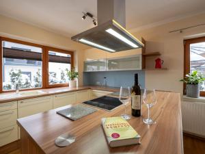 a kitchen with a bottle of wine and two wine glasses at Haus Alpenrose in Waidring