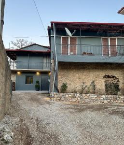 a house with a balcony on the side of it at Theoni Luxury Apartment in Kalavrita