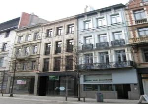 a tall white building on a city street at Charming National Street Room in the Heart of Antwerp in Antwerp