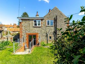 a stone house with a garden in front of it at 2 Bed in Little Walsingham KT093 in Little Walsingham