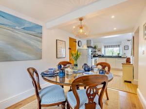 a kitchen and dining room with a table and chairs at 2 Bed in Bethesda 66276 in Llanddeiniolen