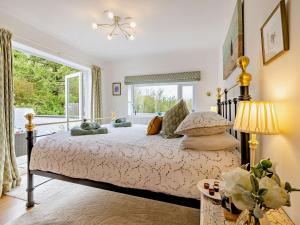 a bedroom with a bed and a large window at 2 Bed in Bethesda 66276 in Llanddeiniolen