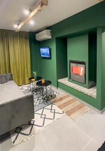 a living room with a fireplace and a couch at Theoni Luxury Apartment in Kalavrita