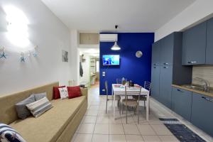a living room and kitchen with a couch and a table at Purpo in Cattolica