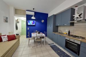 a kitchen and living room with a table and a couch at Purpo in Cattolica +16 photos