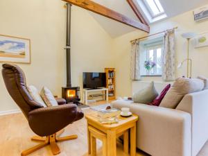 a living room with a couch and a chair at 1 Bed in Padstow 75736 in Saint Ervan