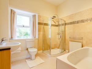 a bathroom with a shower and a toilet and a sink at 6 Bed in Ullapool CA259 in Ullapool