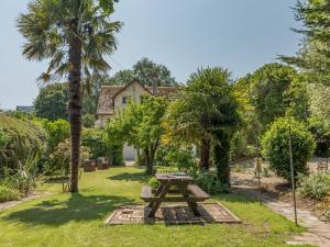 a picnic table in a park with palm trees at 3 Bed in Dawlish 72972 in Dawlish