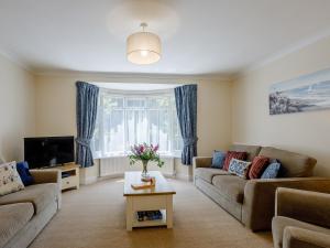 a living room with two couches and a tv at 3 Bed in Dawlish 72972 in Dawlish