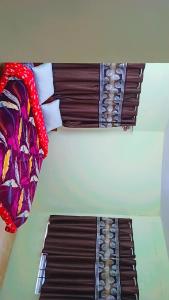 a bedroom with a bed with avertisement at Holiday home in Ooty