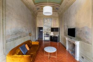 a living room with a couch and a fireplace at numa I Felice Rooms & Apartments in Florence