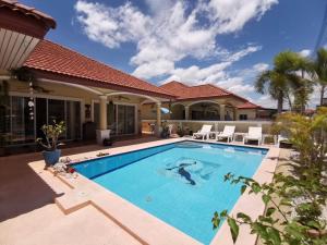 a swimming pool in the backyard of a house at Pool Villa 91 in Ban Nong Pru