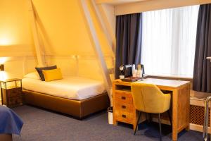 Postel nebo postele na pokoji v ubytování Hotel de Gulden Leeuw
