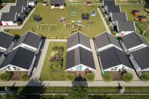 an overhead view of a row of houses with solar panels at Biała Wioska 2 in Ustronie Morskie