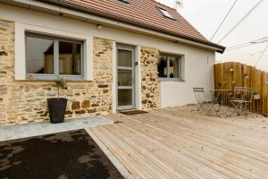 a wooden deck in front of a house at Les Gîtes Warenne - 1 in Saint-Étienne-au-Mont