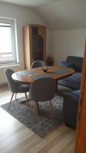a dining room table and chairs in a living room at Apartman Darko in Kupres