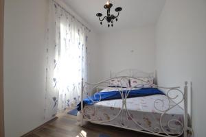a bedroom with a bed and a chandelier at Villa Pistan in Murvica +54 photos