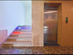 a staircase in a building with a escalator and a elevator at Mangal Residency Rooftop Pool in Udaipur