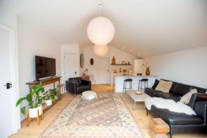 a living room with a couch and a table at Chorlton Stylish Studio & Roof Terrace Apartments in Manchester