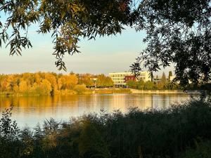 a view of a lake with buildings in the background at Holiday Inn - Strasbourg - Nord, an IHG Hotel in Schiltigheim