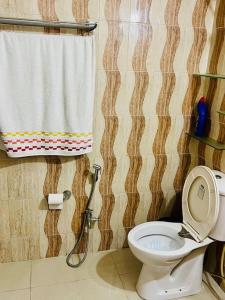a bathroom with a toilet and a shower curtain at Ak22 stays Bardhaman Burdwan in Barddhamān