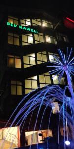 a building with a blue fountain in front of it at Hotel Dev Haweli , Port Blair in Port Blair