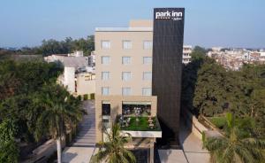 an external view of a building with a clock tower at Park Inn by Radisson Ayodhya in Ayodhya