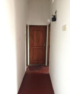 un pasillo vacío con una puerta de madera en una habitación en Kandy Mount View hotel en Peradeniya