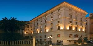 a large white building with lights on it at art'otel Rome Piazza Sallustio, Powered by Radisson Hotels in Rome