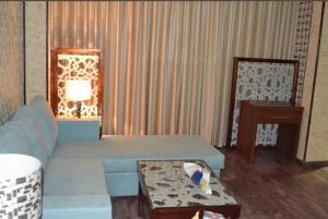 a living room with a couch and a table at Cozy studio Minutes to Cornich & Bahrain bridge in Al Khobar