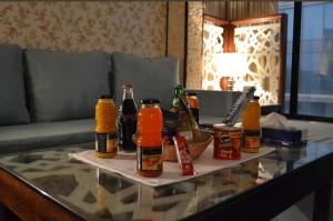 a table with bottles of beer and condiments on it at Cozy studio Minutes to Cornich & Bahrain bridge in Al Khobar