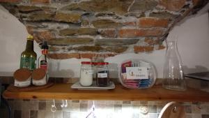 a shelf with bottles of milk and other items on it at Dal Pescatore in Arenzano