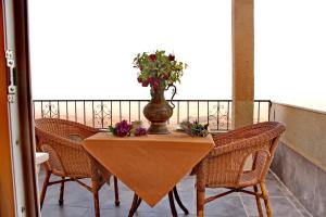 a table with a vase with flowers on a balcony at HH Babil Konağı in Mardin