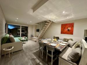 a living room with a couch and a table in it at Duplex skis aux pieds centre village - 6 couchages - 2 salles de bain in La Clusaz