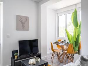 salon ze stołem i telewizorem w obiekcie Akicity Campolide Sun w Lizbonie
