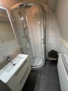 a bathroom with a shower and a sink at Appartement Warmond in Warmond