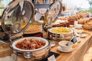 a buffet with various dishes of food on a table at PANORAMA OCEANFRONT SUITE in Nha Trang