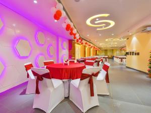 a banquet hall with red and white tables and chairs at Hotel Anju Shree Inn in Jaipur