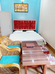 a room with a table and chairs and a bed at Paradise Home stay in Rāni Pokhri