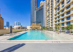 a swimming pool in a city with tall buildings at Luxurious 3BR Apartment Amazing view of Burj Khalifa in Dubai