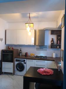 a kitchen with a washer and a table in it at Forest View Pipera in Voluntari