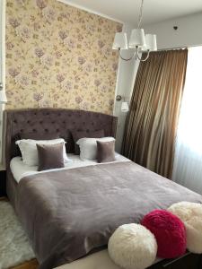 a bedroom with a large bed with two pillows at Forest View Pipera in Voluntari