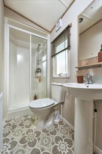 a bathroom with a toilet and a sink and a shower at Mowbreck Park in Kirkham