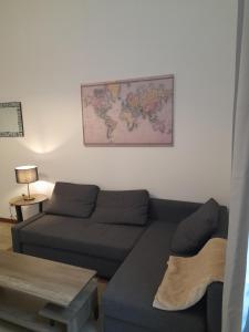a living room with a couch and a map on the wall at San Pietro 55 in Rome