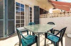 a table and chairs sitting on a patio at Appartamento Altamar Las Americas in Playa de las Americas