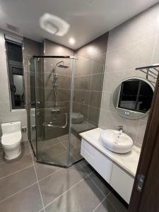 a bathroom with a shower and a toilet and a sink at Vinhomes Marina in Xóm Niêm